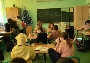 Uczniowie obserwują przez mikroskop organizmy poruszające się w kropli wody