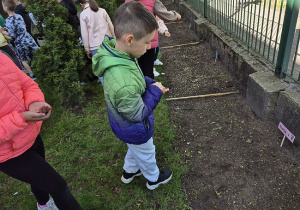 Uczeń kl. 1 sieje nasionka w ramach projektu Aktywni Błękitni w ogrodzie szkolnym